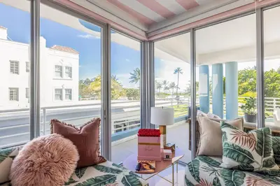 a living room with a couch and large windows at Boutique Suite with Huge Terrace and Rooftop Pool in Miami Beach