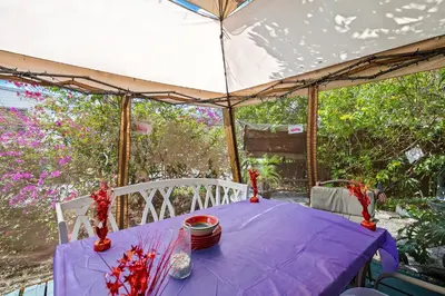 a table in a tent with a purple table cloth at Comfy BNB w/ King Bed + Work/Travel + Beach 8 Min in Hallandale Beach