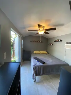 a bedroom with a bed and a ceiling fan at Cozy House in Fort Lauderdale