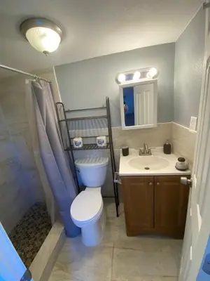 a bathroom with a toilet and a sink at Cozy House in Fort Lauderdale