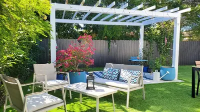 a white pergola with chairs and a table in a yard at Casa Cuba in Little Havana, Brickell, Calle 8 and 10 minutes to the Beach FREE PARKING in Miami