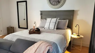 a bedroom with a bed and a clock on the wall at Casa Cuba in Little Havana, Brickell, Calle 8 and 10 minutes to the Beach FREE PARKING in Miami