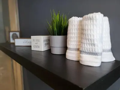 a table with three white knitted towels and a potted plant at Casa Cuba in Little Havana, Brickell, Calle 8 and 10 minutes to the Beach FREE PARKING in Miami