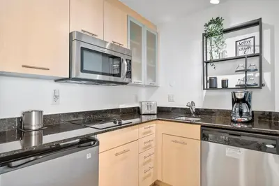 a kitchen with a sink and a microwave at Avi Lux Stay in Fort Lauderdale