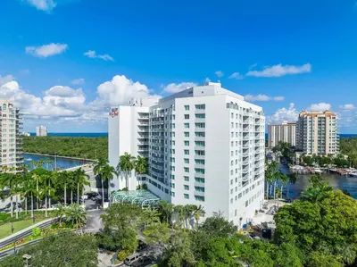 a tall white building next to a river at Avi Lux Stay in Fort Lauderdale