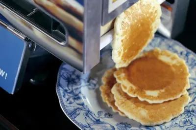 a stack of pancakes on a blue and white plate at Hotel Gaythering - Gay Hotel - All Adults Welcome in Miami Beach
