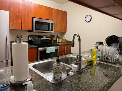 a kitchen with a sink and a counter top at Rooftop Pool with Water View in Miami