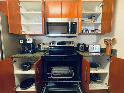 a kitchen with a stove and a microwave at Rooftop Pool with Water View in Miami