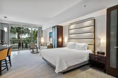 a hotel room with a bed and a living room at Junior Suite 2 at Sorrento Residences- Miami Beach home in Miami Beach