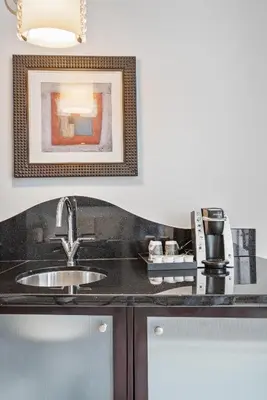 a kitchen counter with a sink and a picture on the wall at Junior Suite 2 at Sorrento Residences- Miami Beach home in Miami Beach