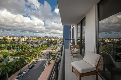 a balcony with a chair and a view of a city at Luxury 1BD/1BT Apartment in Downtown Doral in Miami