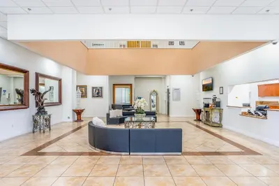 a living room with a couch and a table at South River Suites in Medley