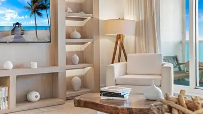 a living room with a white chair and a table at Luxurious Private Condo at 1 Hotel & Homes -945 in Miami Beach