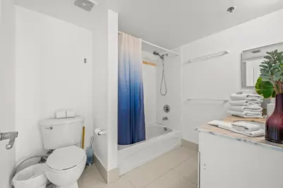 a white bathroom with a toilet and a shower at Luxurious Condo with PARKING in Brickell Miami in Miami