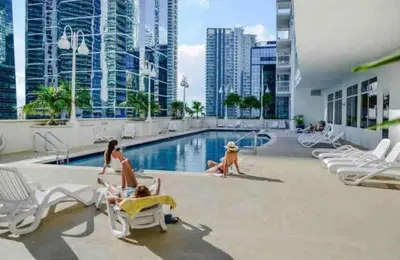 a group of people in the swimming pool at a hotel at Luxurious Condo with PARKING in Brickell Miami in Miami