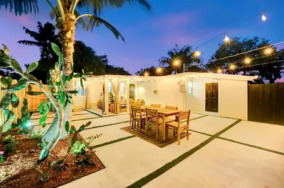 a patio with a table and chairs at night at Casa Del Sol in Hollywood