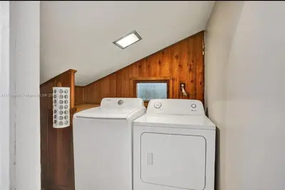 a laundry room with two washing machines in it at Beach House w/ Heated Pool in Hollywood