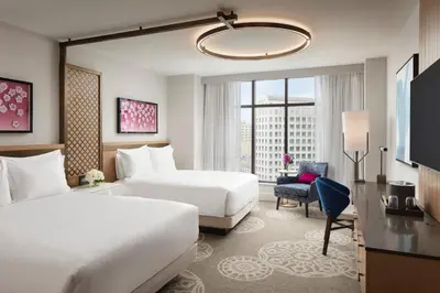 a hotel room with two beds and a window at Loews Coral Gables Hotel in Miami