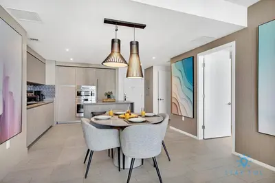 a kitchen and dining room with a table and chairs at Oceanfront Balcony - Amazing Pools - Gym in Hollywood