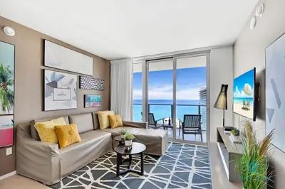 a living room with a couch and a table at Oceanfront Balcony - Amazing Pools - Gym in Hollywood