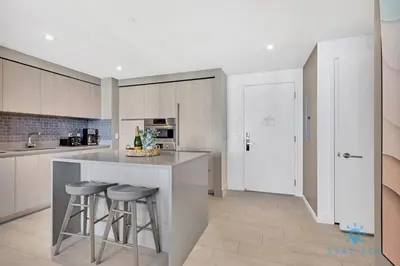 a kitchen with a counter and stools in it at Oceanfront Balcony - Amazing Pools - Gym in Hollywood