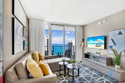a living room with a couch and a view of the ocean at Oceanfront View - Balcony - Hot Tub - Gym in Hollywood