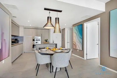 a kitchen and dining room with a table and chairs at Oceanfront View - Balcony - Hot Tub - Gym in Hollywood
