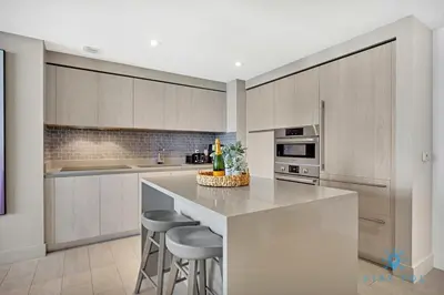 a kitchen with a large island with bar stools at Oceanfront View - Balcony - Hot Tub - Gym in Hollywood