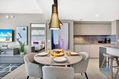 a kitchen and dining room with a table and chairs at Exclusive Condo - Near Beach - Free Valet Parking in Hollywood