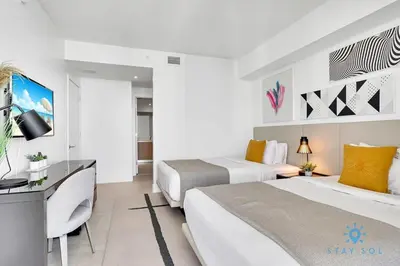 a hotel room with two beds and a television at Exclusive Condo - Near Beach - Free Valet Parking in Hollywood