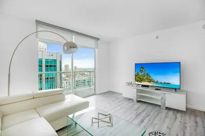 a living room with a white couch and a flat screen tv at Amazing Penthouse In beautiful Brickell 42 floor!! Free Garage Parking in Miami