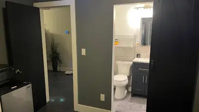 a bathroom with a white toilet and a sink at HEART OF WILTON MANORS in Fort Lauderdale