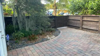 a patio with a fence and a brick walkway at HEART OF WILTON MANORS in Fort Lauderdale