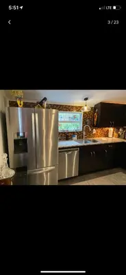 a kitchen with a stainless steel refrigerator and a sink at HEART OF WILTON MANORS in Fort Lauderdale
