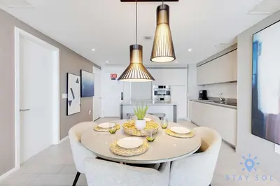 a kitchen and dining room with a table and chairs at High Floor 2BR -2 BA - Resort Fees & Parking Incl in Hollywood