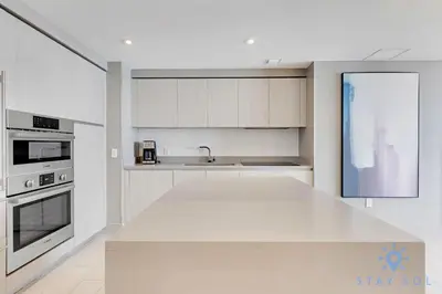 a kitchen with white cabinets and a white counter top at High Floor 2BR -2 BA - Resort Fees & Parking Incl in Hollywood