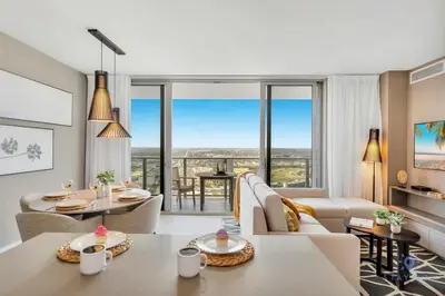 a living room with a couch and tables and chairs at Amazing Pools - Near Beach - Parking Included in Hollywood