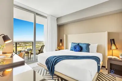 a bedroom with a large bed and a large window at Amazing Pools - Near Beach - Parking Included in Hollywood