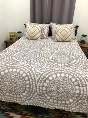 a bed with a white comforter and two pillows at Modern Spanish Villa- Pool- By River-Tropical !!! in Fort Lauderdale