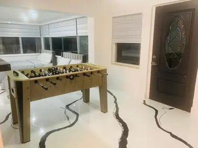 a living room with a foosball table and a couch at Modern Spanish Villa- Pool- By River-Tropical !!! in Fort Lauderdale