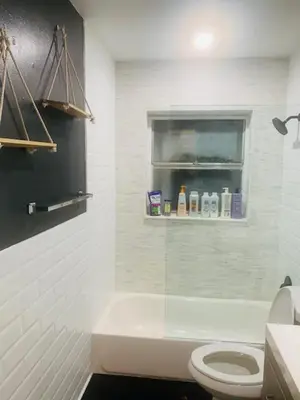 a white bathroom with a toilet and a window at Modern Spanish Villa- Pool- By River-Tropical !!! in Fort Lauderdale