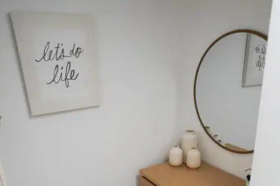 a bathroom with a mirror and a table with candles at 4 bed full condo in Miami with skyline & sea view in Miami