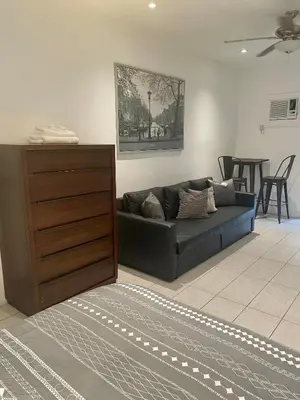 a living room with a black couch and a table at Modern Riverview Apartments in Fort Lauderdale
