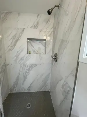 a bathroom with a marble shower with a mirror at Downtown FTL apartments on the River in Fort Lauderdale