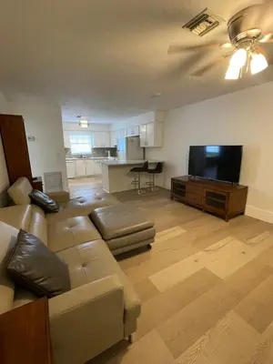 a living room with a couch and a flat screen tv at Cozy Downtown Apartments on Water in Fort Lauderdale
