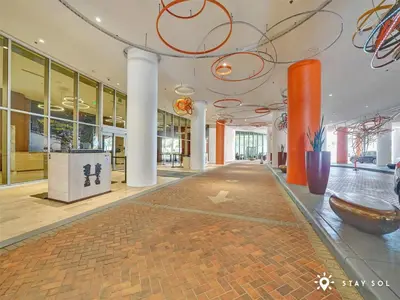 an empty lobby with orange columns and a large room at Insane Ocean View Balcony - Beachfront Resort - Pools in Hollywood
