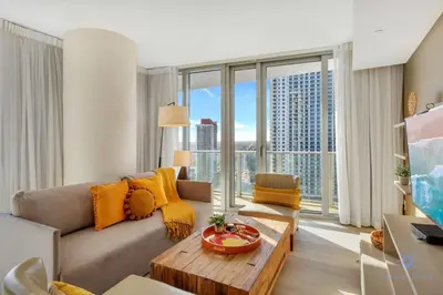 a living room with a couch and a large window at Insane Ocean View Balcony - Beachfront Resort - Pools in Hollywood