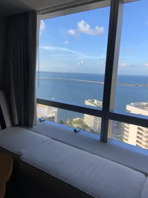 a room with a large window with a view of the ocean at Four Seasons Hotel Miami - Luxury Private Residences in Miami