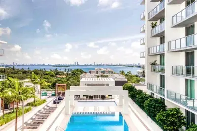 an apartment building with a pool and a view of the water at BRAND NEW TOP FLOOR IN THE HEART OF MIAMI in Miami