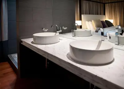 a bathroom with two sinks on a marble counter at Leslie Hotel Ocean Drive in Miami Beach